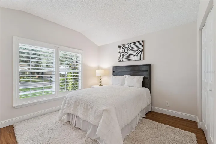 12' x 10'6" Bedroom #2 w/ laminate floor &amp; Plantation style shutters