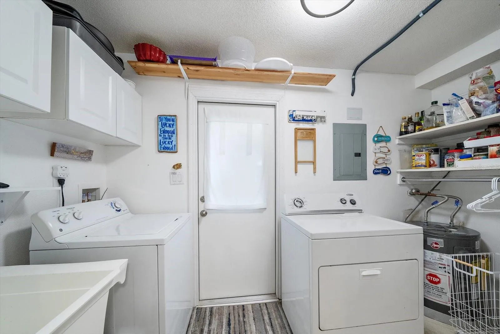full laundry room off of the kitchen, with exit door