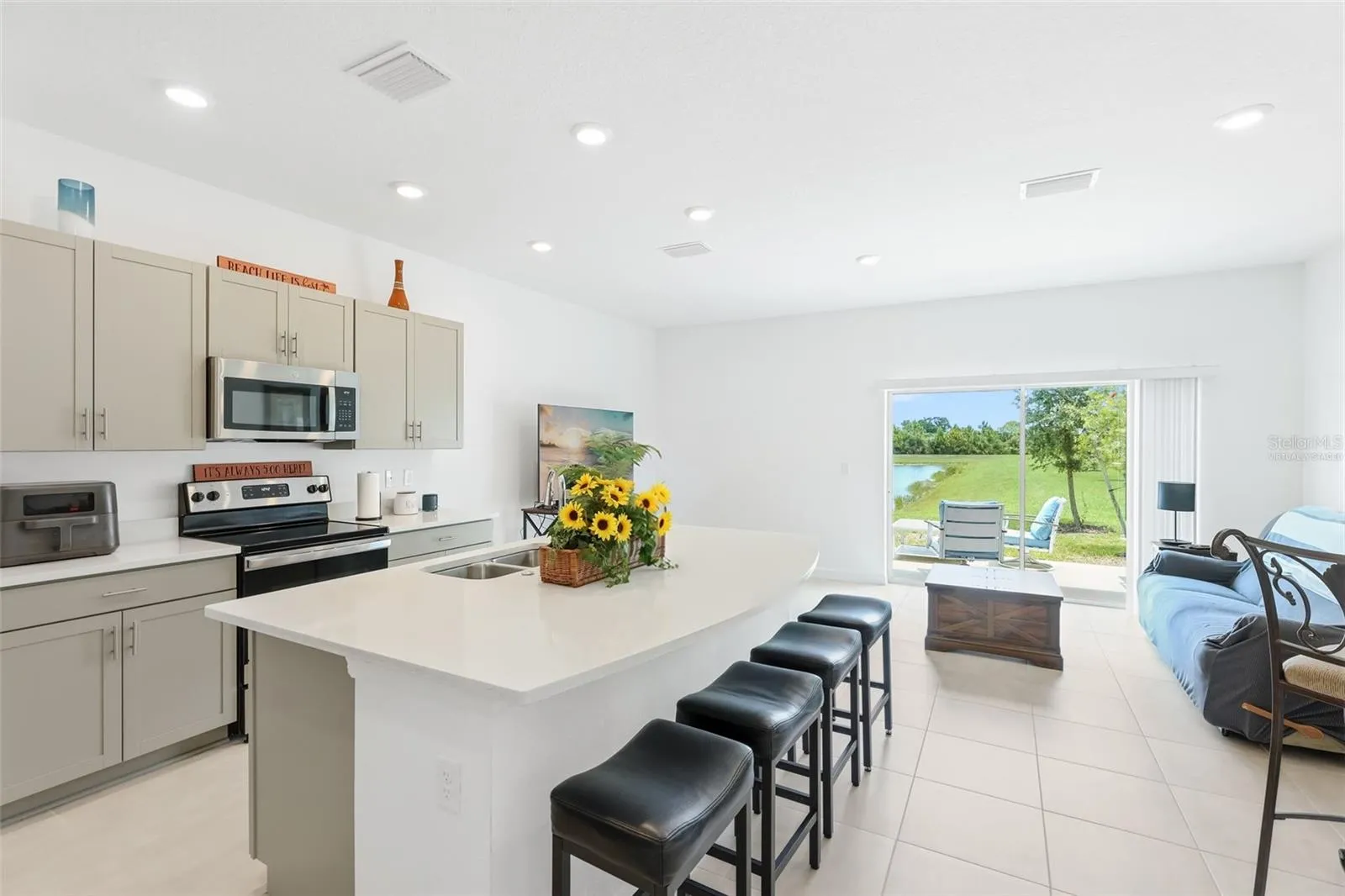 Kitchen and great room. Virtually staged: personal items removed