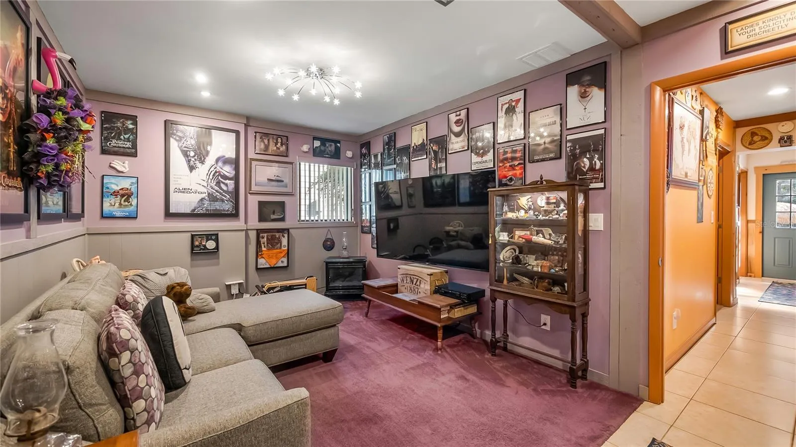 Guest bedroom with private entrance off the front of the home. Being used as a den/TV room