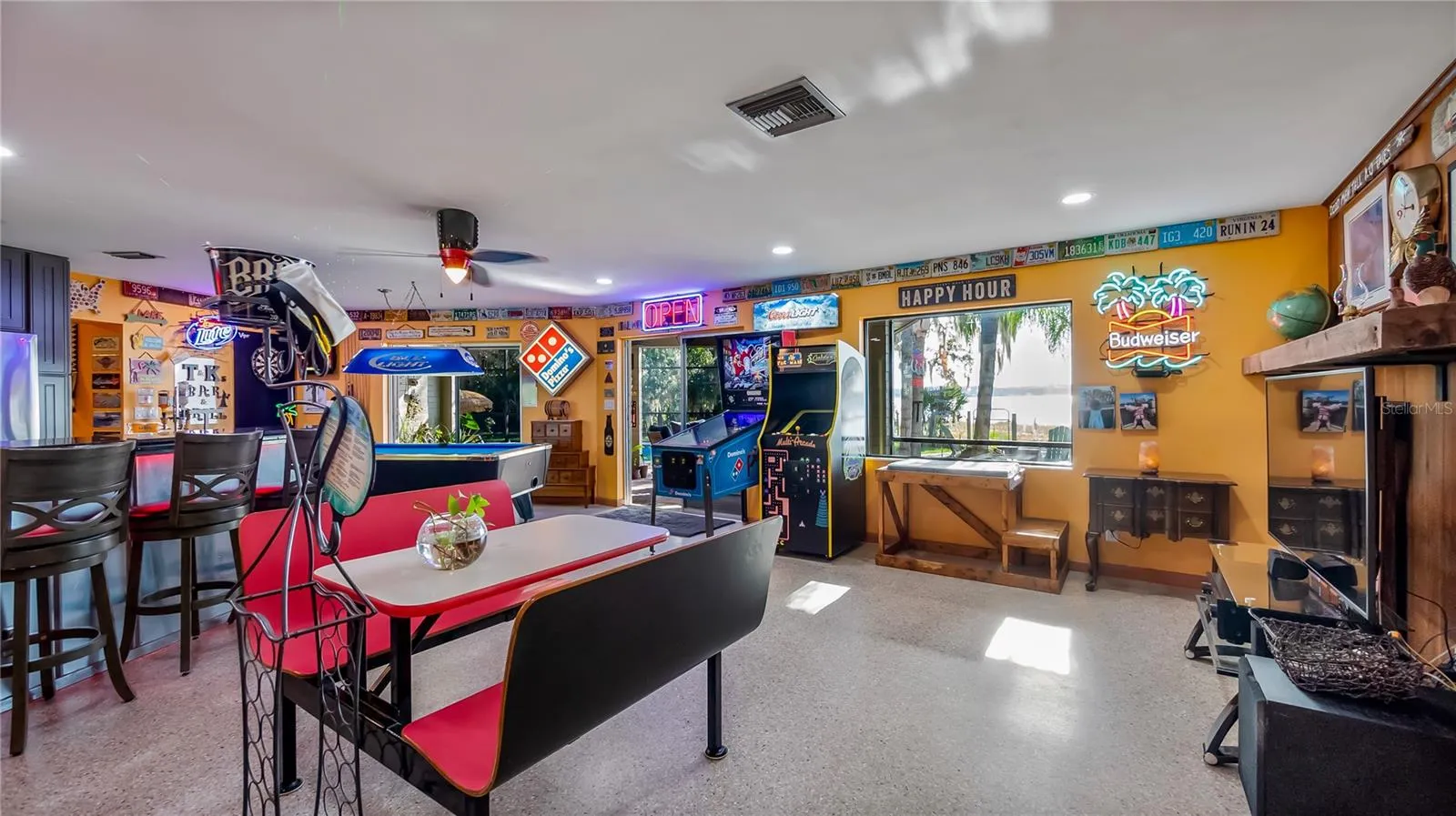 Main Home - Great room/kitchen/living room combo: Living room used as gathering space for game room fun. Two Sliders go out to covered back porch and screened in pool