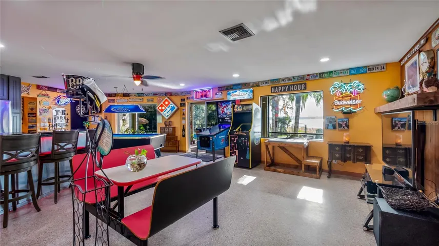 Main Home - Great room/kitchen/living room combo: Living room used as gathering space for game room fun. Two Sliders go out to covered back porch and screened in pool