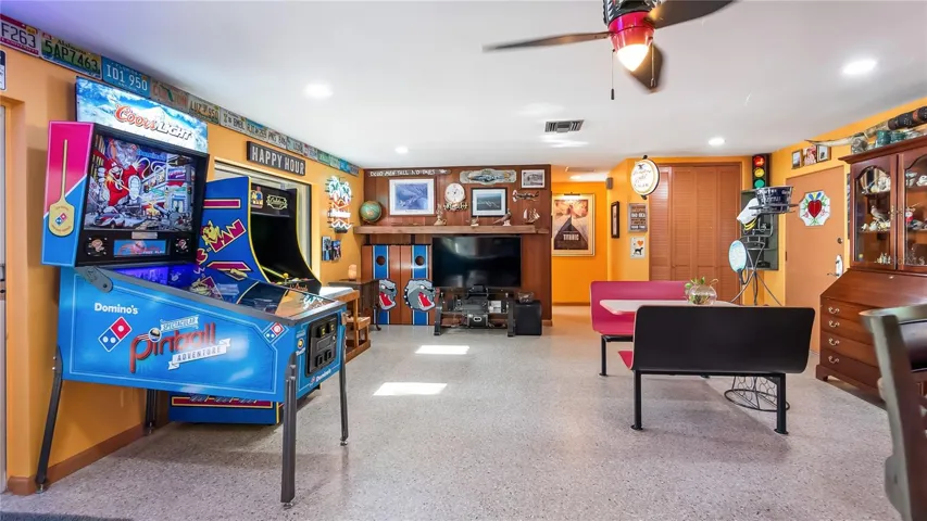 Main Home - Great room/kitchen/living room combo: Living room used as gathering space for game room fun. Two Sliders go out to covered back porch and screened in pool