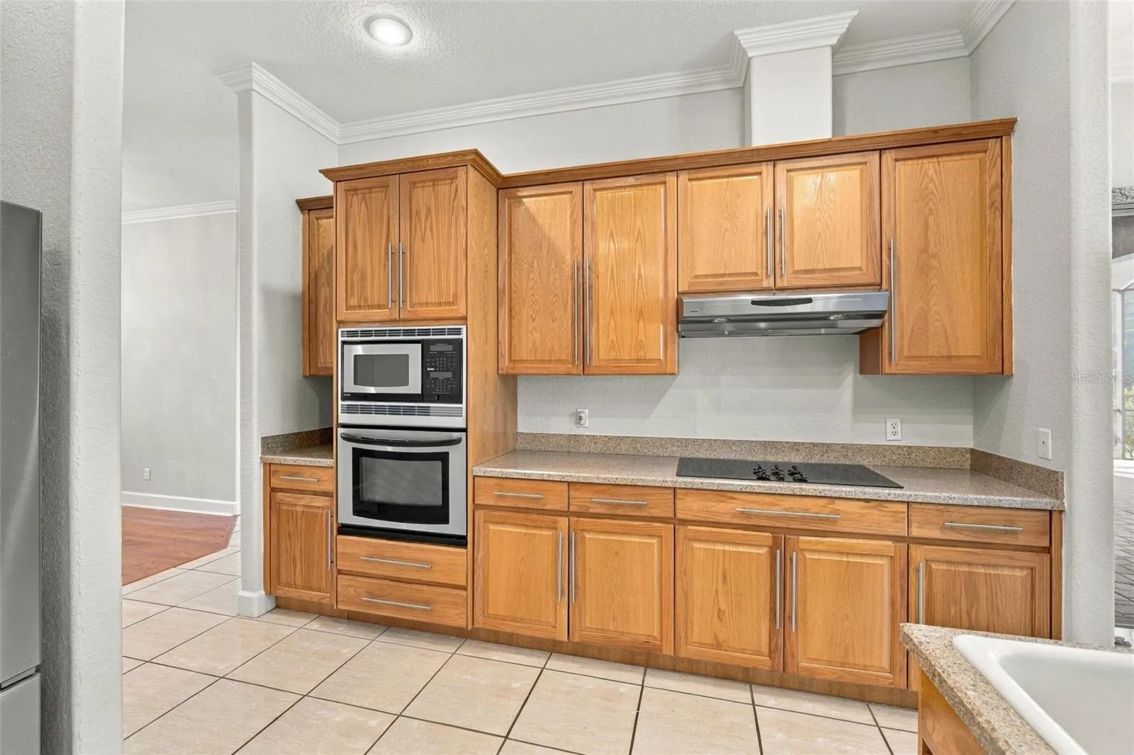 Kitchen with Built in Oven &amp; Microwave. Cook Top with Vented Hood! Crown Molding just adorns this Kitchen's Real Wood Cabinetry!