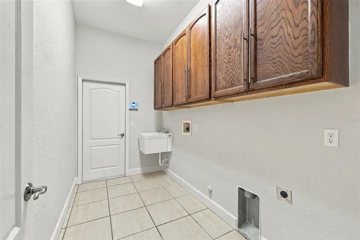Laundry Room with Laundry Sink and Built In Cabinetry