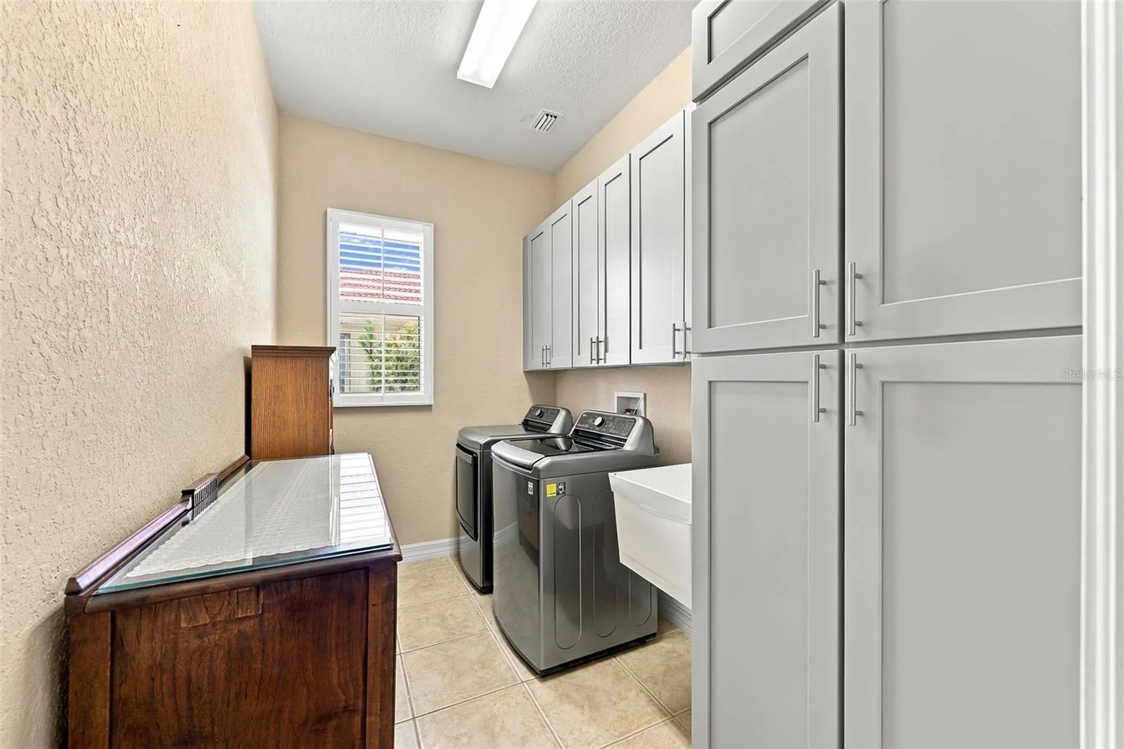 Laundry room is incredible with tons of storage and a utility sink.  Notice the overall size of the room!