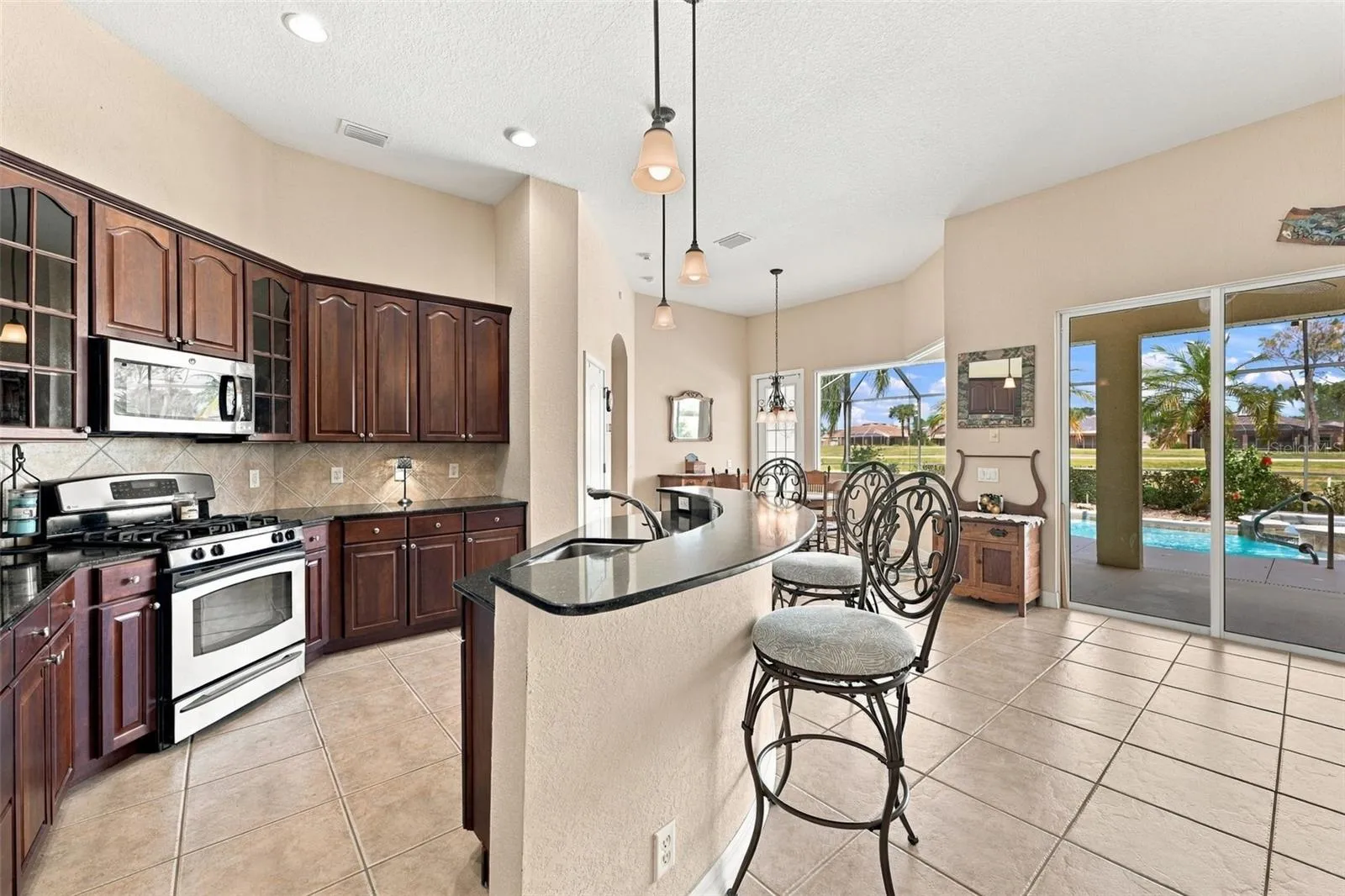 Beautiful dark cherry all wood cabinets are stunning against the softer paint tones on the walls and floors. Lots of room for multiple cooks along with plenty of cabinets and storage.  What a view to the outside!