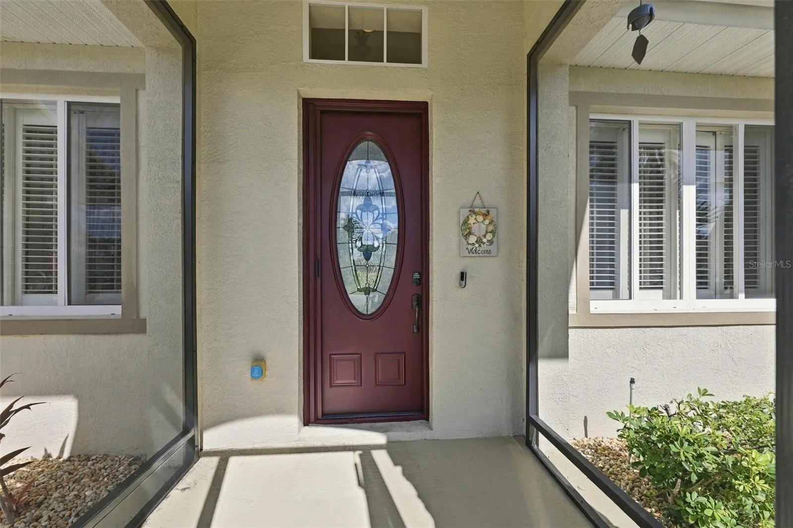 The front screen porch offers protection from the elements and security for packages.  The lovely stain-glass paneled door brings light and beauty into the home.