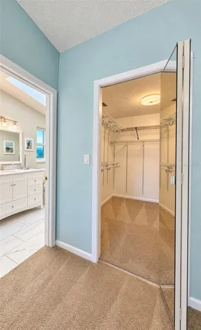walk-in closet next to bathroom