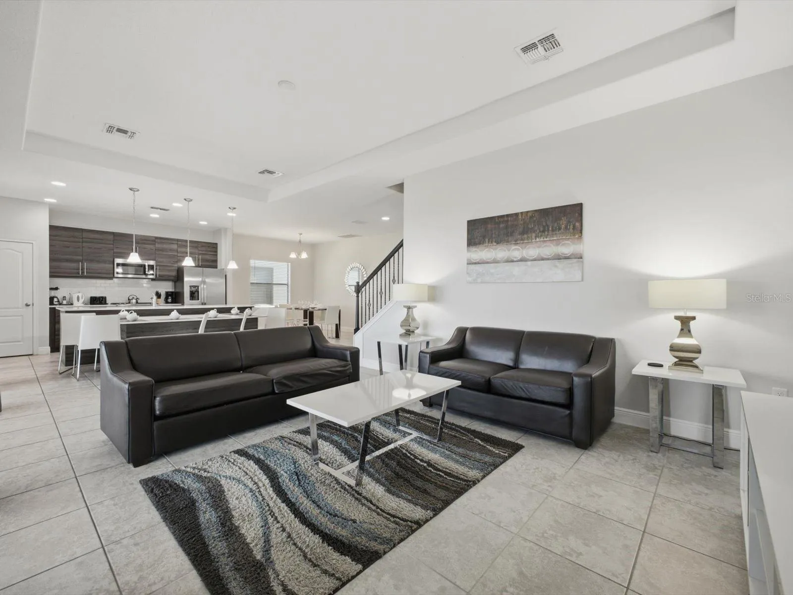 Living room with view into kitchen