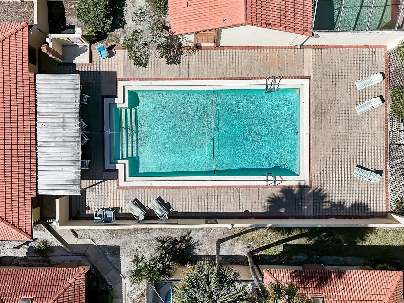 The Island Club HOA covers professionally maintained landscaping and grounds, roof maintenance, exterior painting, and access to the community clubhouse, fitness center, and Olympic-size community swimming pool. Community-wide exterior painting is planned for 2027.