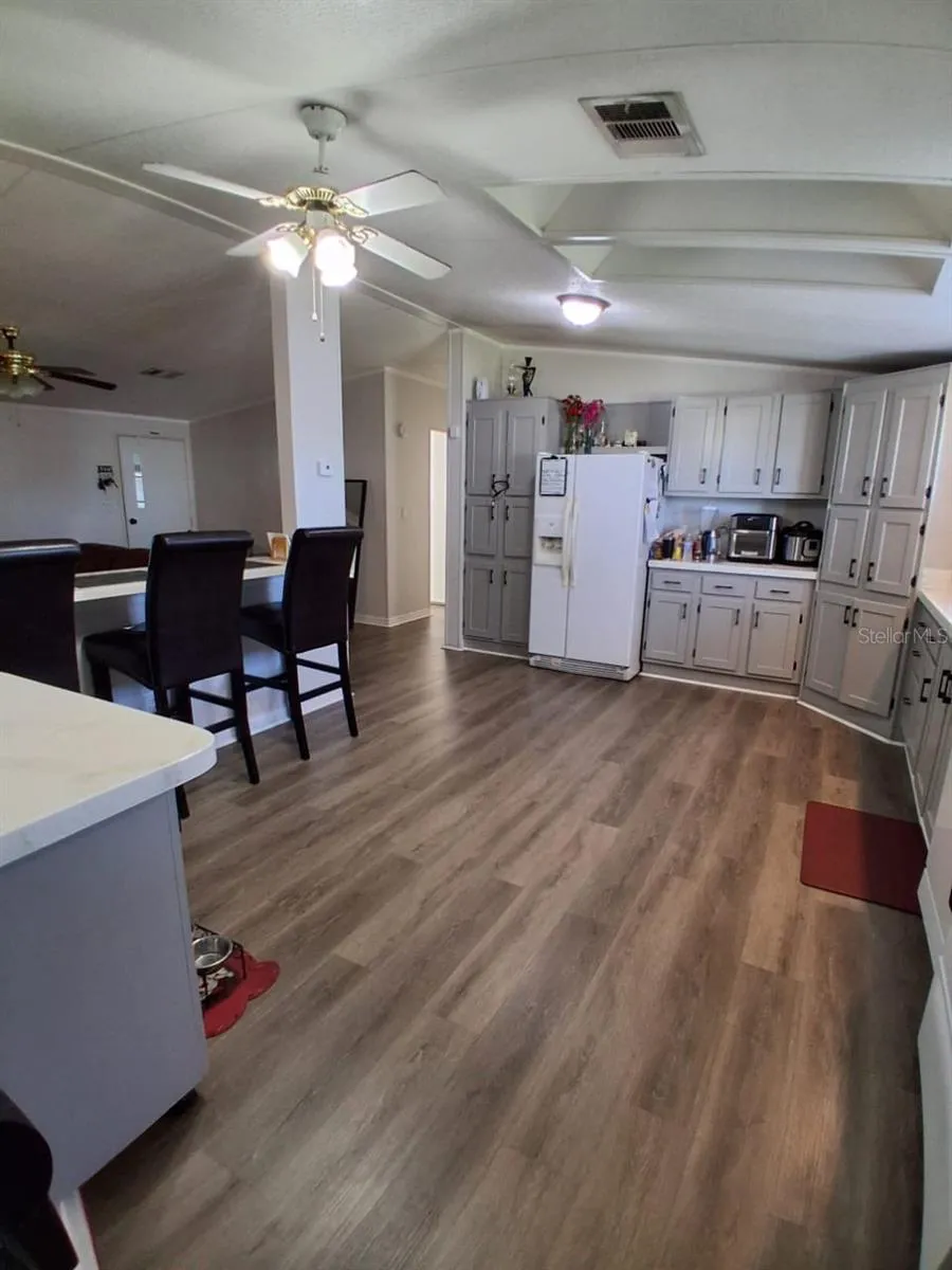 Shows kitchen bar area that looks into living room.  To the very left of this photoshows a moveable kitchen Island!  What convenience!To