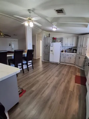 Shows kitchen bar area that looks into living room.  To the very left of this photoshows a moveable kitchen Island!  What convenience!To