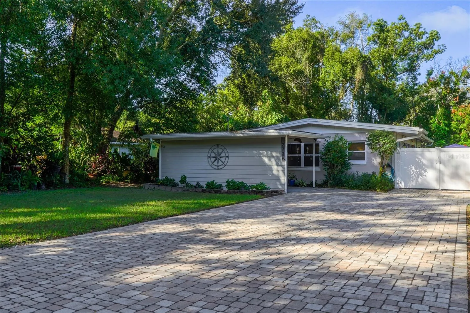 Expansive paver driveway and covered entry.