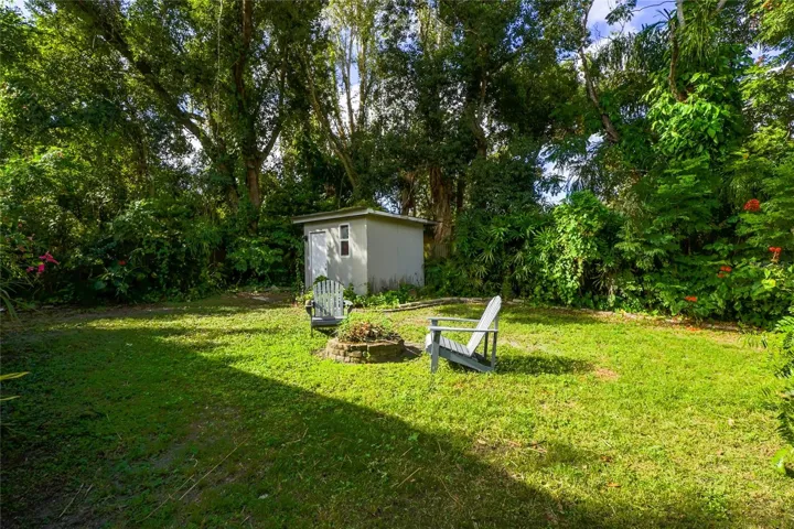 Mature trees and lush greenery frame the backyard.