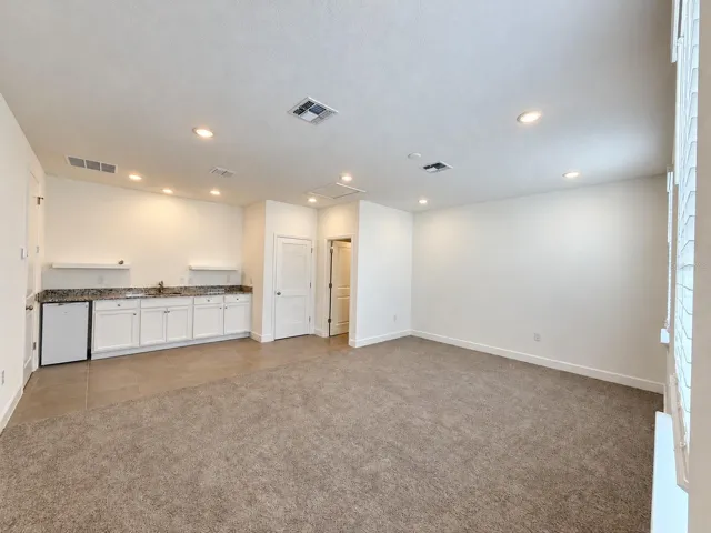 Studio: living area with kitchenette and refrigerator