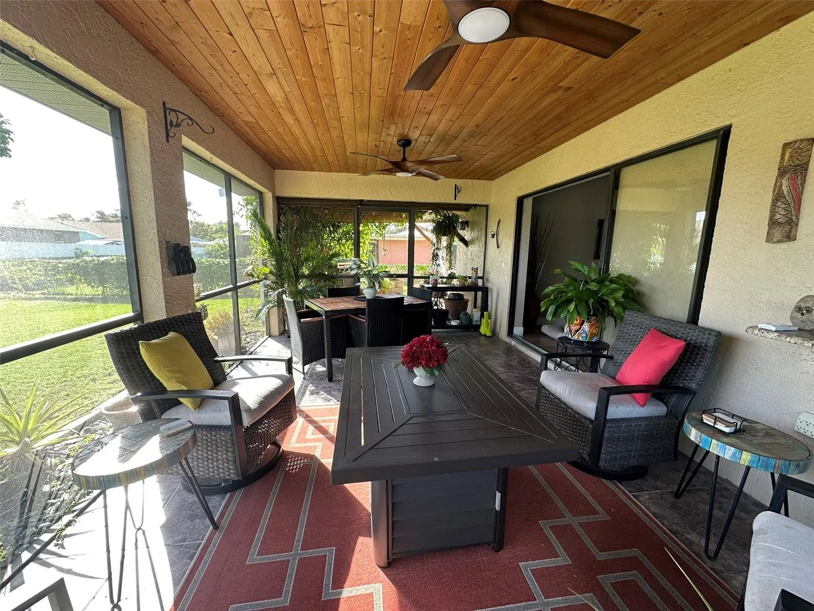 Lanai and pergola beyond it. The sliders to the dining room pock outside the house.