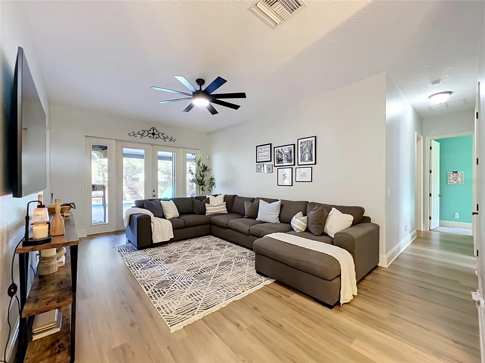 Living room with french doors to the screened pool area