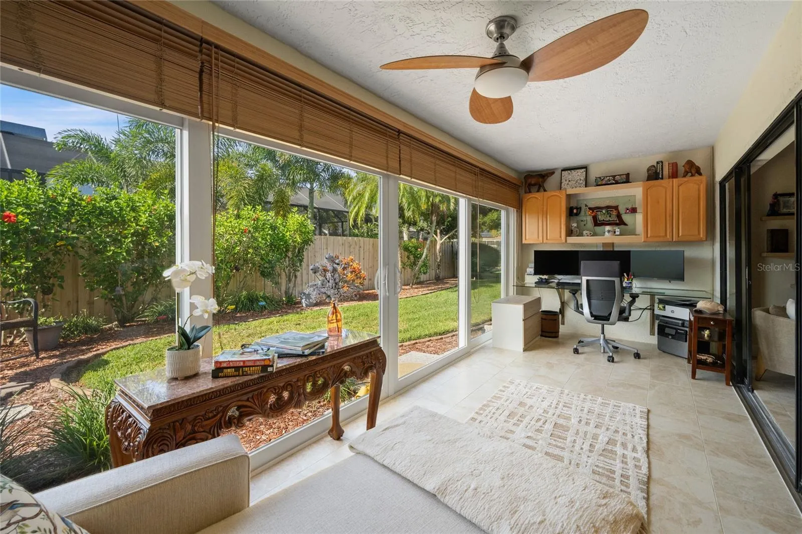 ENCLOSED LANAI HAD IMPACT/HURRICANE RATED DOUBLE PANE INSULATED SLIDING GLASS DOORS, WOOD HORIZONTAL BLINDS AND TILE FLOOR.