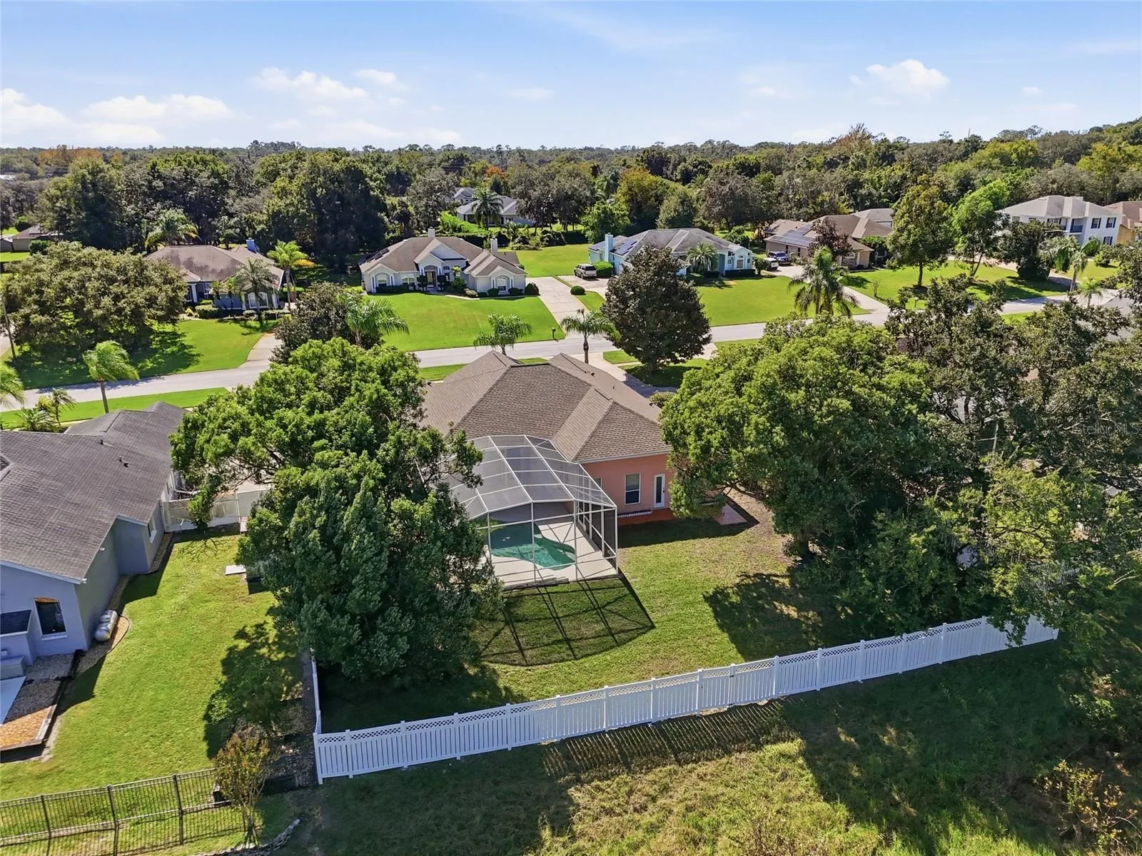 Rear aerial of 226 Alexandra Woods Drive shows the backyard, screened pool enclosure, andsurrounding Glen Abbey neighborhood.