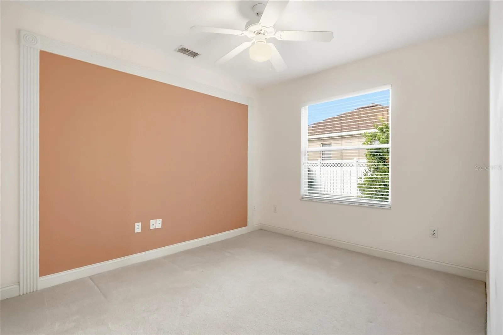 Third guest bedroom beside a full bathroom, with separation from the other bedrooms in thethree-way split floor plan.