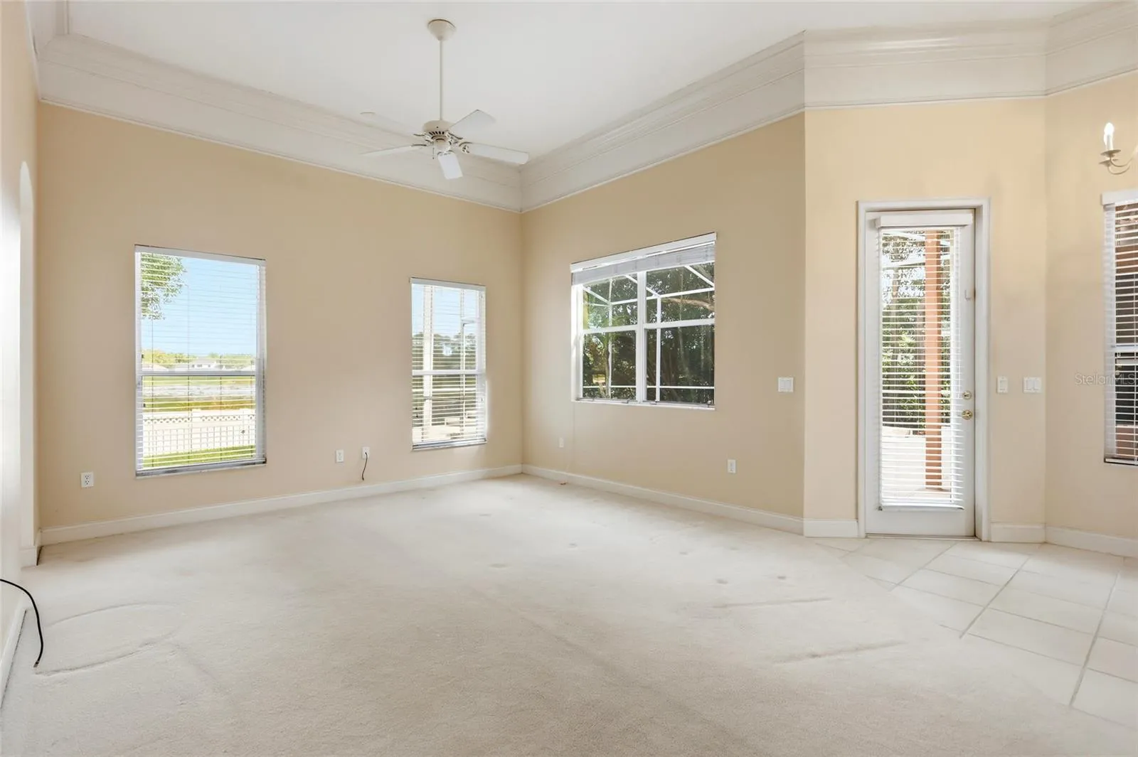 Lake views and natural light complement the family room, with crown molding and aconnection to the outdoor living spaces.