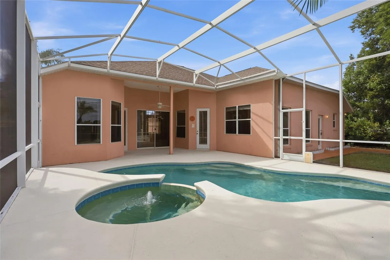 Pool and covered porch connect directly to the kitchen/family room, formal living room, andprimary suite.