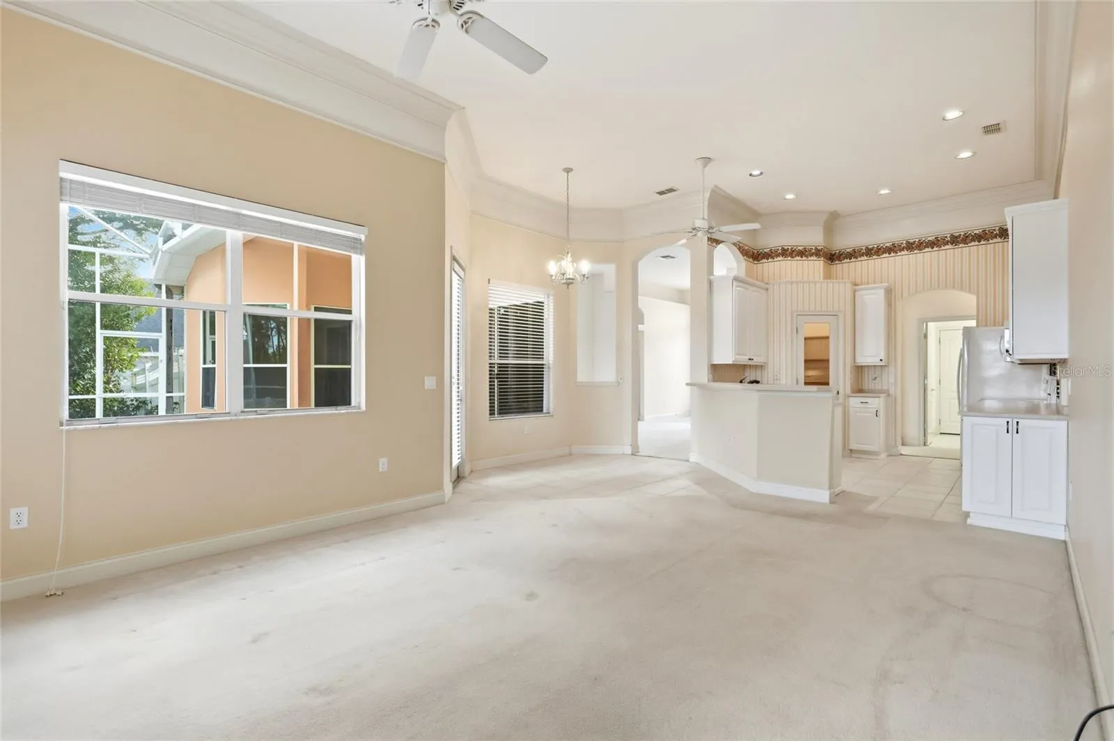 The family room opens to the kitchen and breakfast nook, with direct access to the coveredporch and screened pool.
