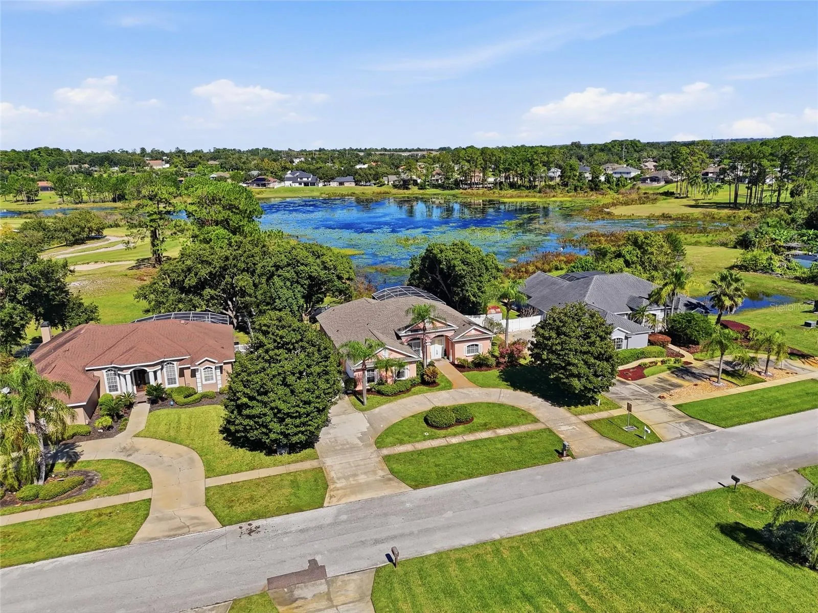 Elevated lake-view setting on approximately 0.47 acre in Glen Abbey, with mature trees anda circular driveway.