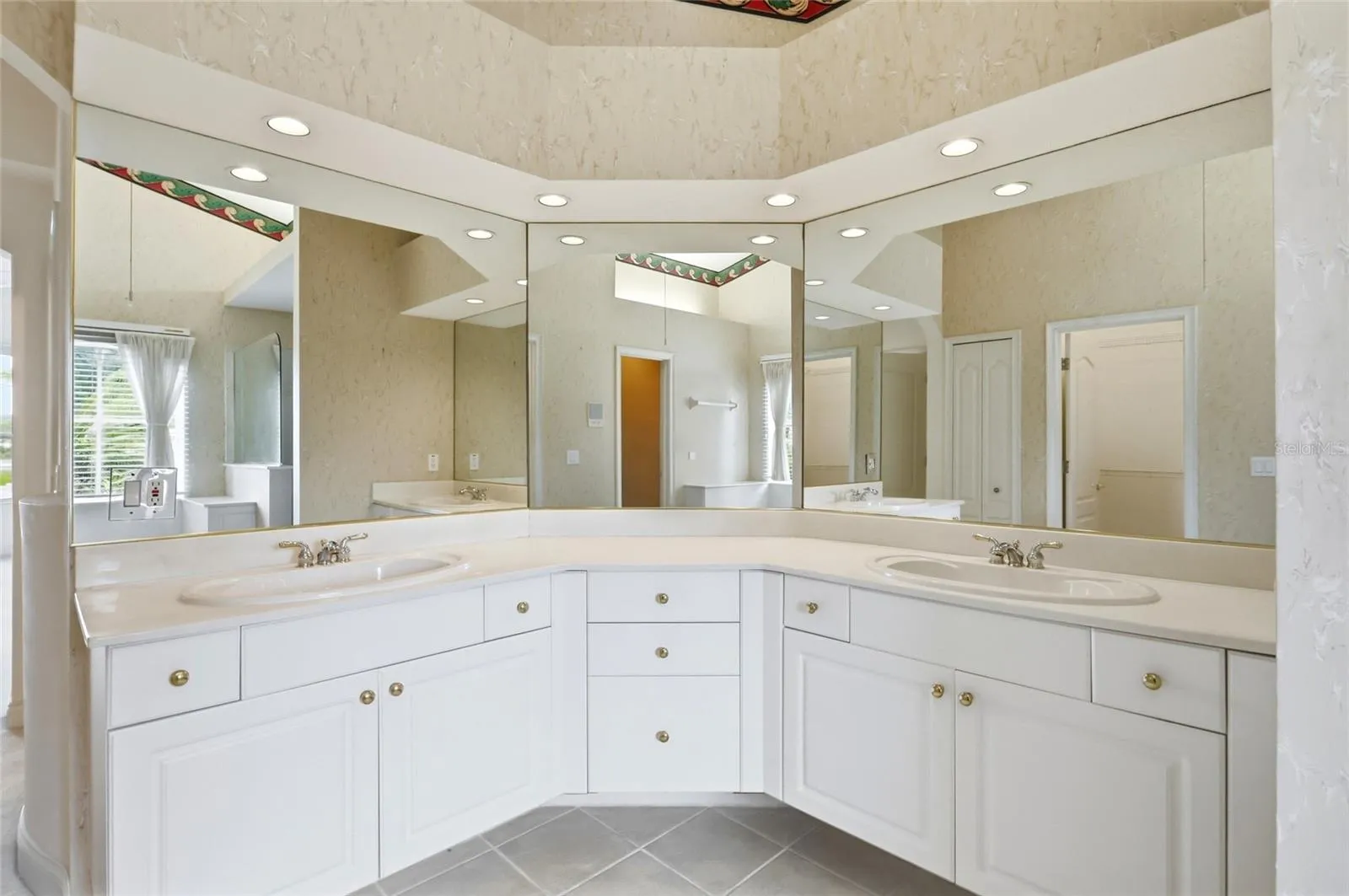 Dual-sink vanity with generous counter space and cabinet storage in the primary bathroom.