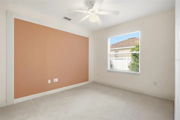 Third guest bedroom beside a full bathroom, with separation from the other bedrooms in thethree-way split floor plan.