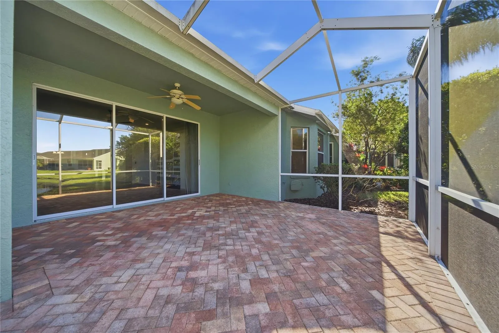 Partially covered lanai with a screened in enclosure that extends.