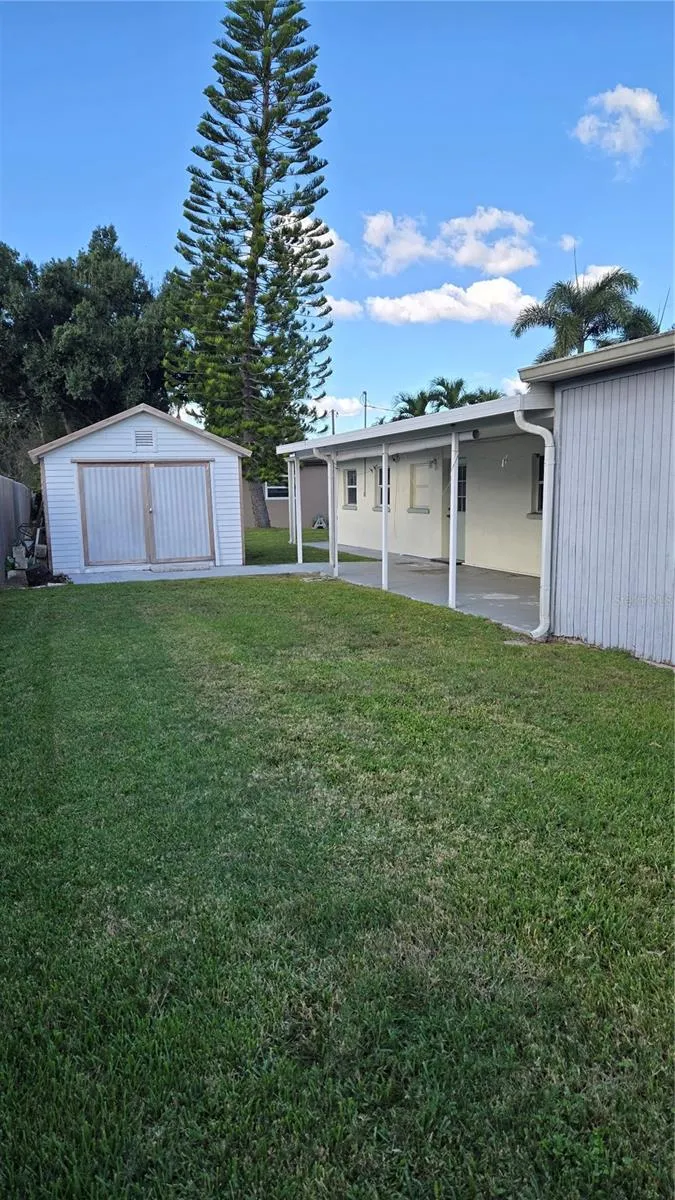Back yard with storage shed and rear patio