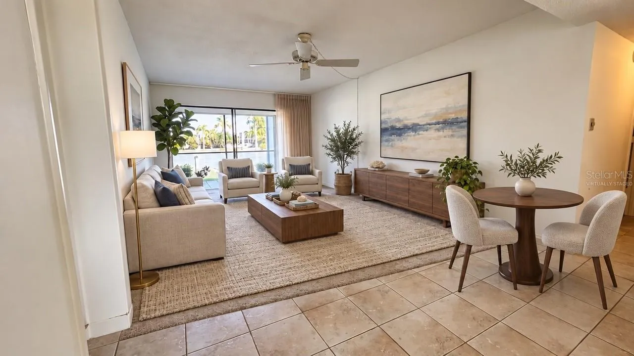 Virtually staged living room and dining area with tile floors, ceiling fan, and sliders to the screened lanai. Photo is virtually staged; furnishings are not included.
