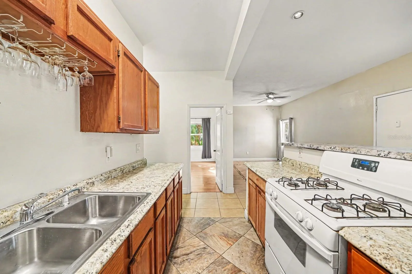 Spacious Kitchen Featuring Dual Gas Ranges, Granite Tops & Wood Cabinetry