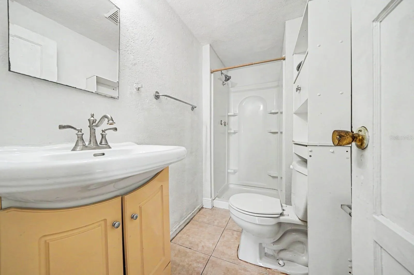 Guest Bath with Yellow Vanity, Shower Enclosure & Ceramic Tile
