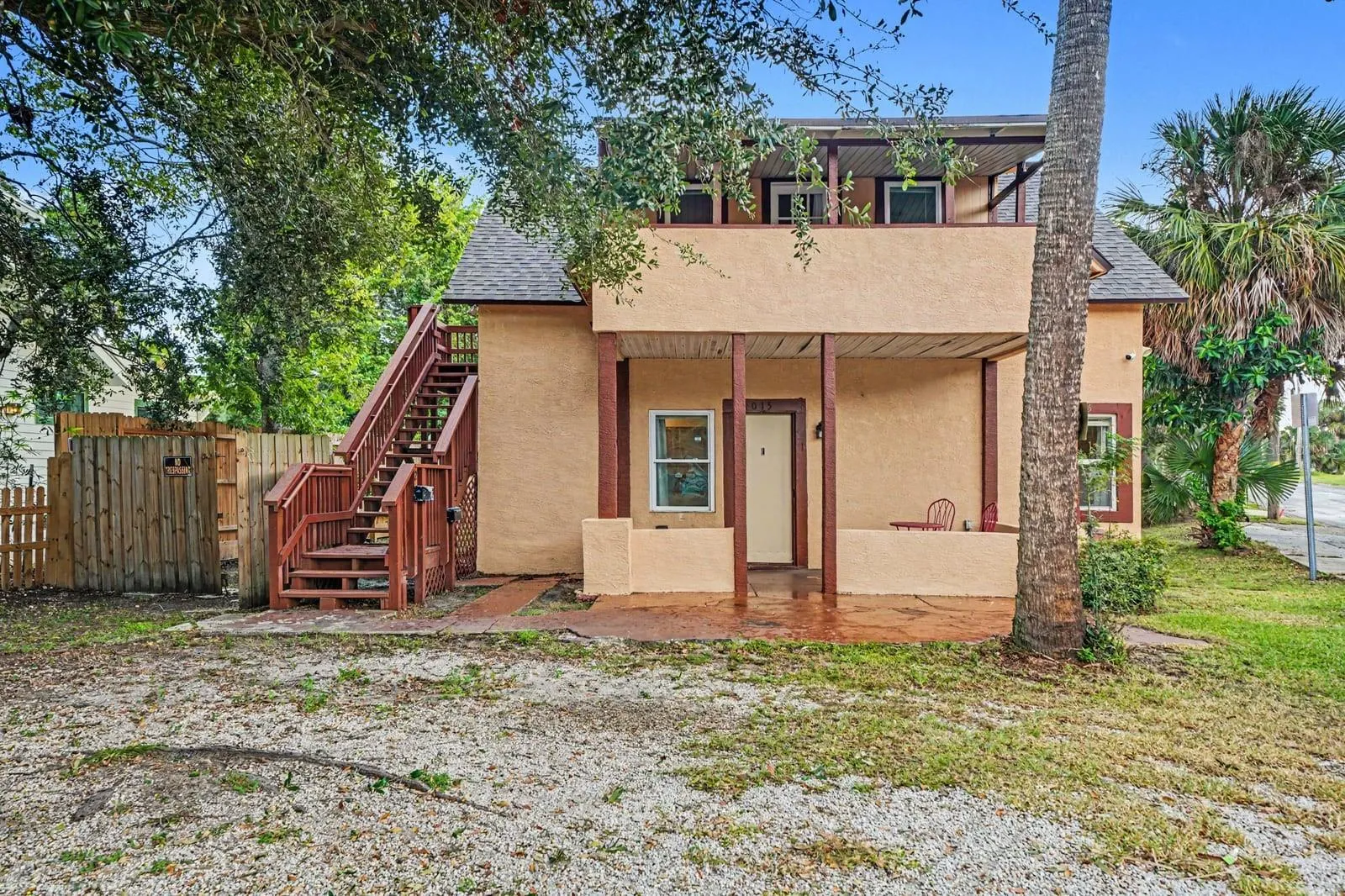 Two-Story Home With Brick Steps, Red Railings & Mature Trees