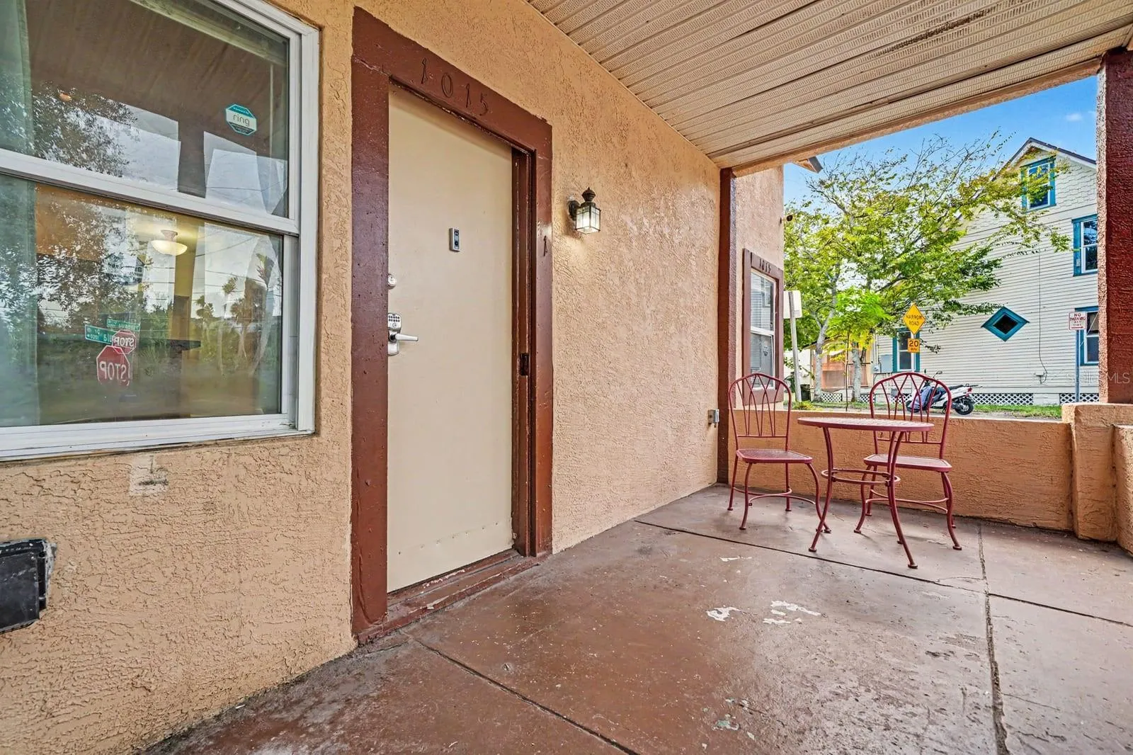 Front Porch Seating Area With Covered Overhang & Windows