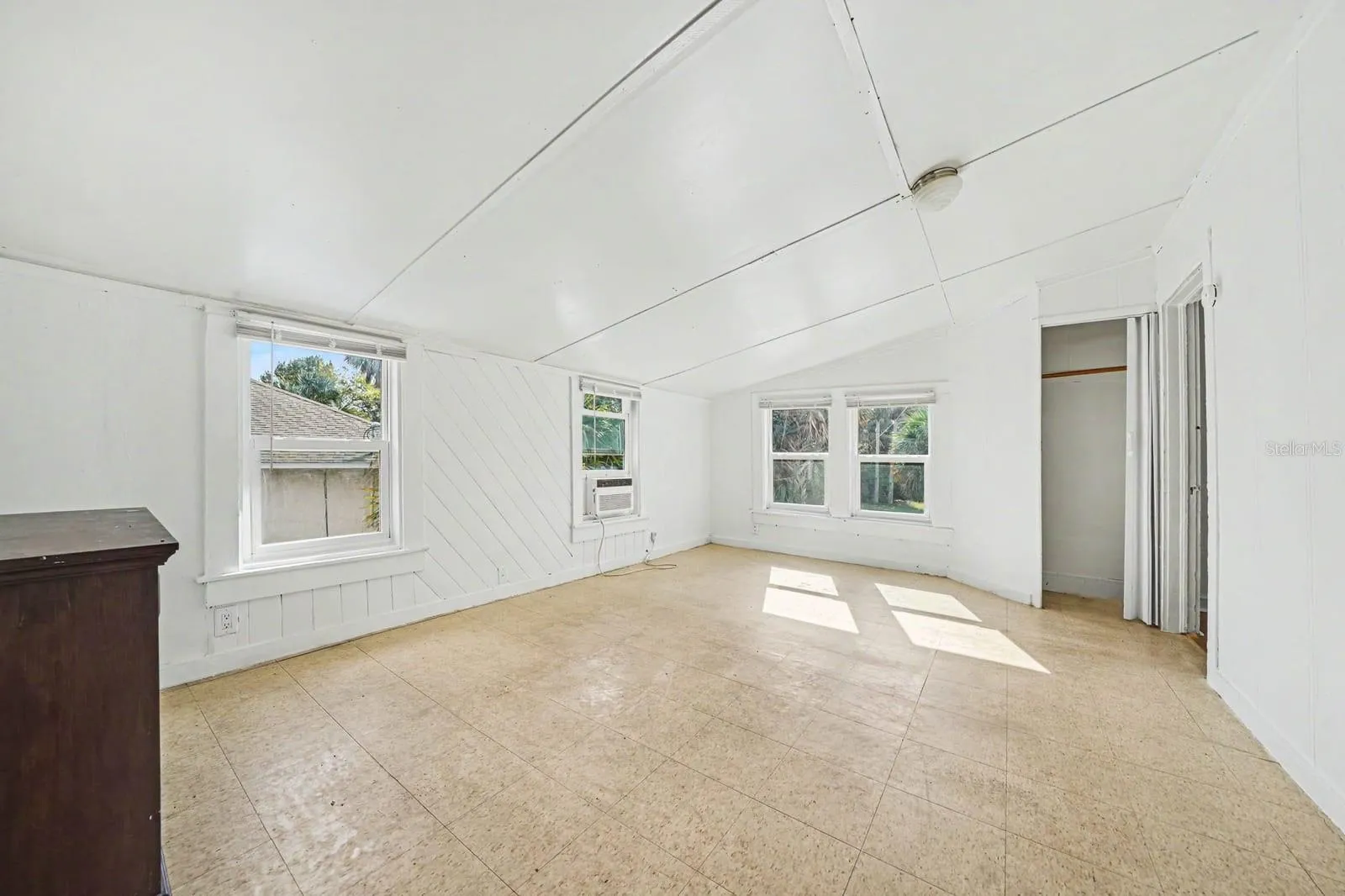 Vaulted Ceiling Living Space with Multiple Windows & Natural Light