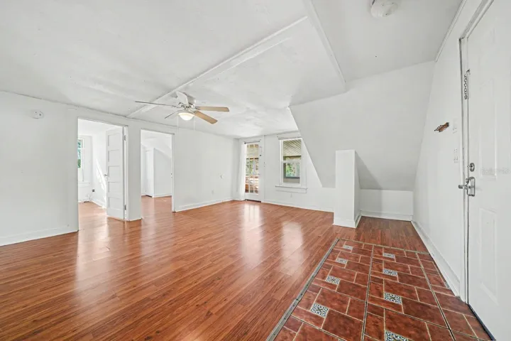 Open Upper Level with Sloped Ceilings, Multiple Doors & Fan