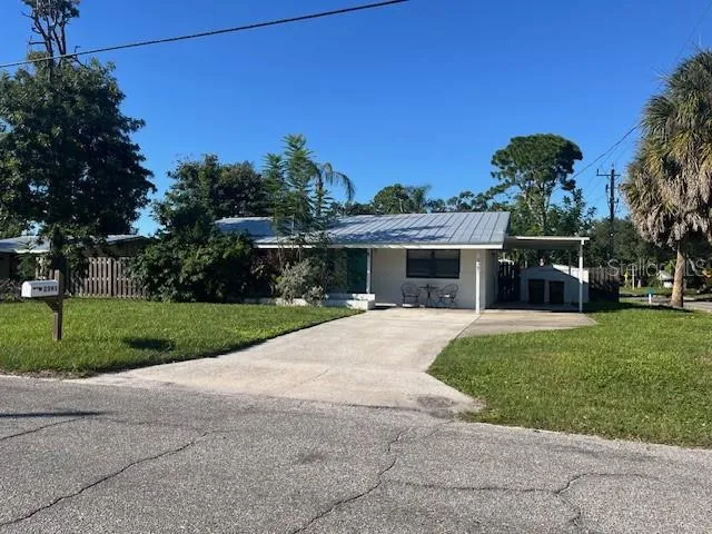 Covered Sitting area in front, fully fenced yard, Carport for one vehicle and plenty of space in the driveway
