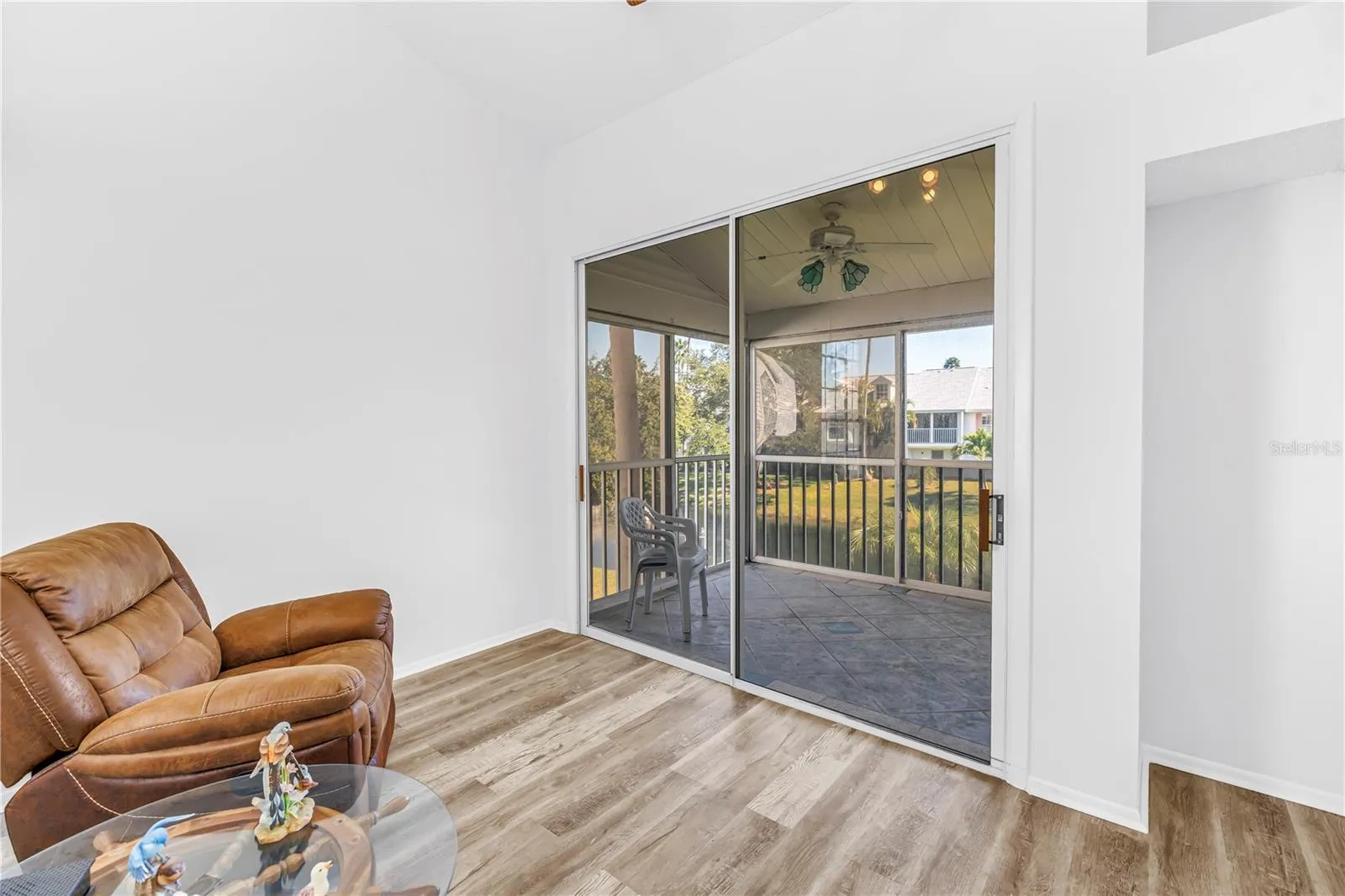 Looking out to screened in patio to lake view