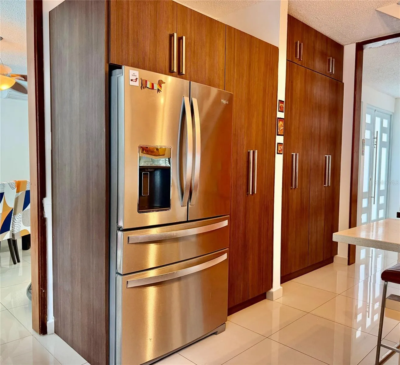 Kitchen refrigerator and storage cabinetry.