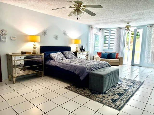 Primary bedroom with access to the covered balcony.