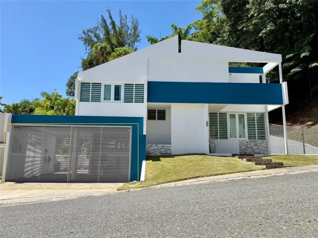 Front exterior and attached two-car carport.