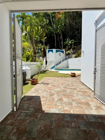 Access from the covered area to the patio and pool.