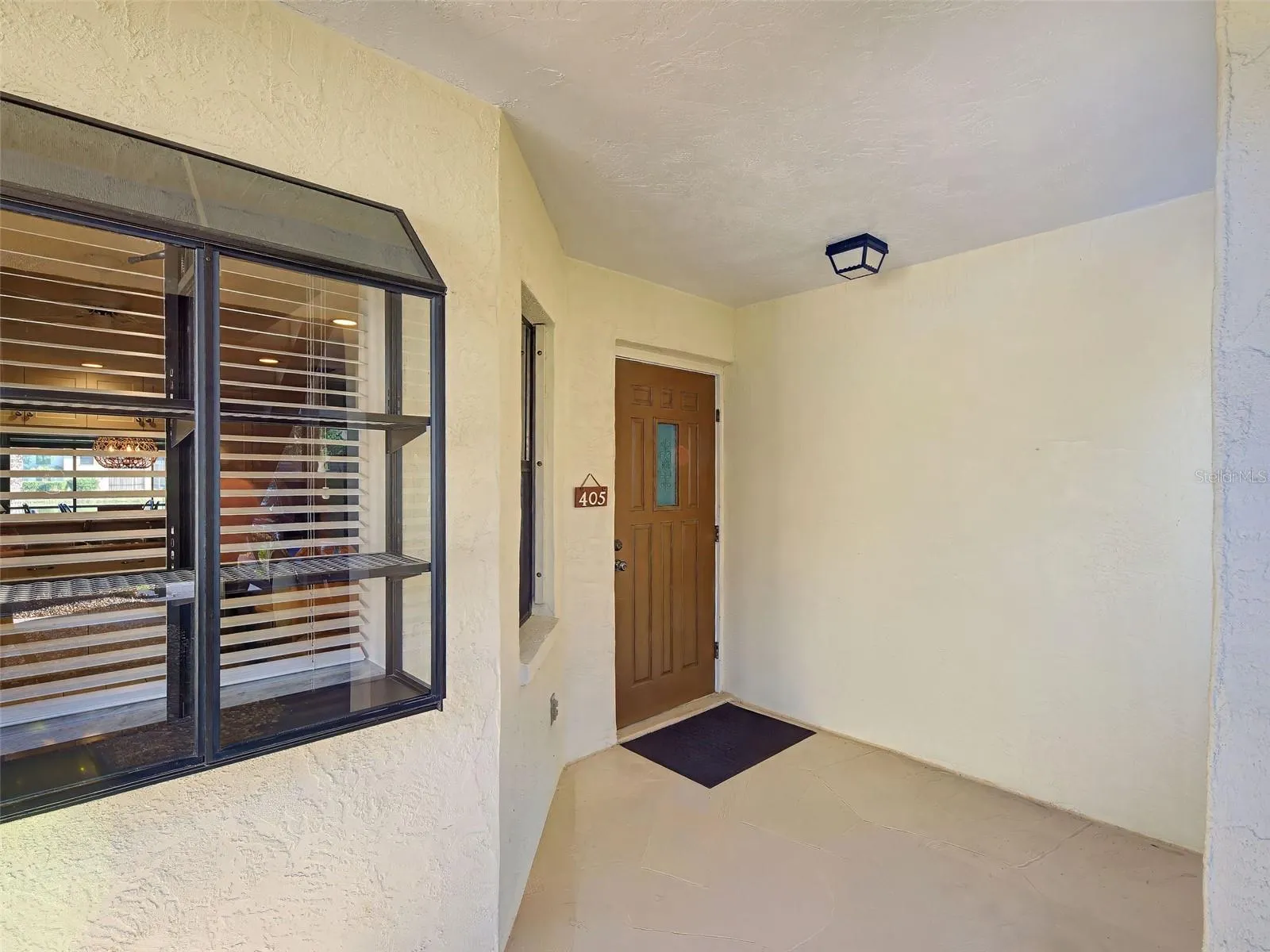 COVERED FRONT ENTRY - CREATE A COZY SITTING AREA.
