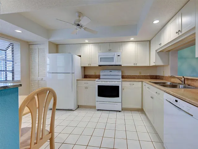 ROOMY KITCHEN WITH AMPLE CABINETS AND COUNTERSPACE.