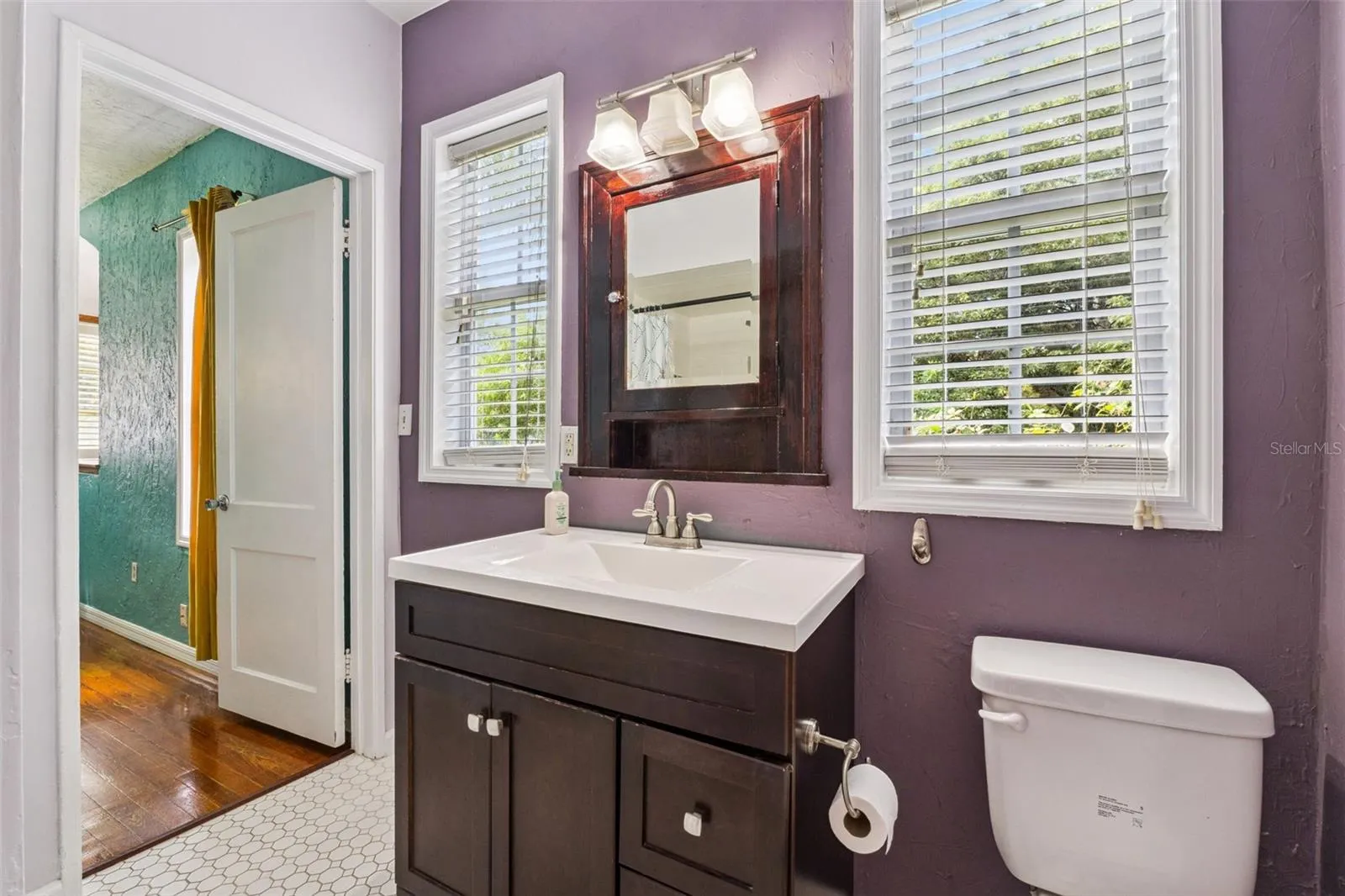 Full bathroom with natural light and a generous vanity