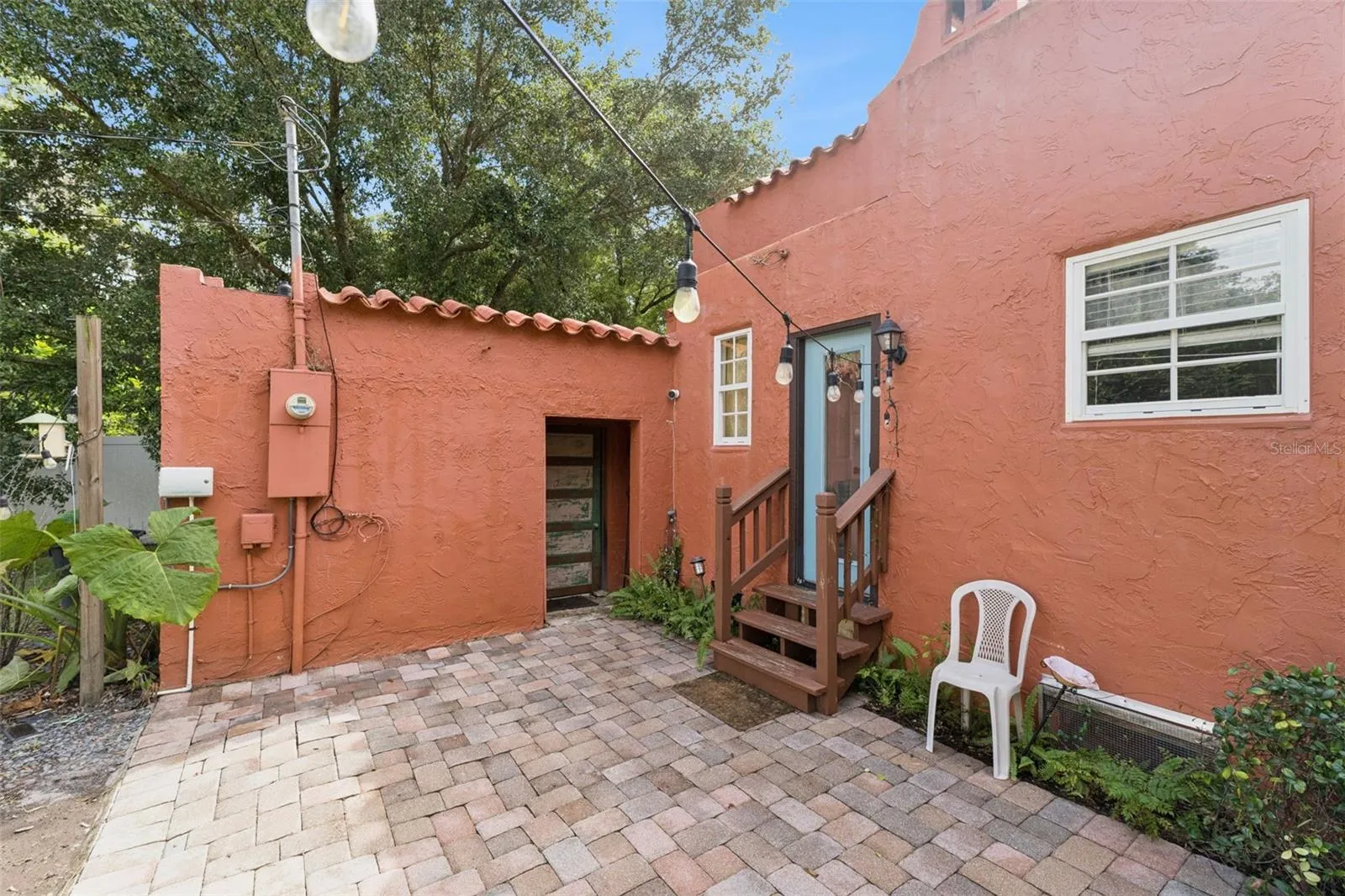 A brick patio offers space for outdoor seating just behind the home
